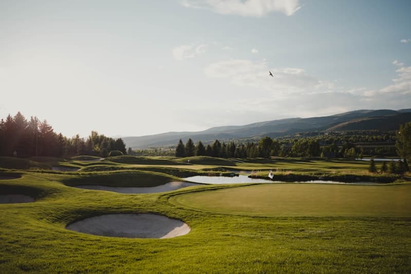 Aerial sunrise view of a pristine private golf course fairway