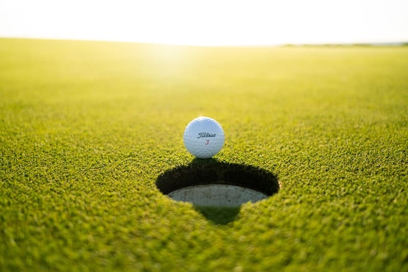 Golden-hour light over an immaculate private golf fairway